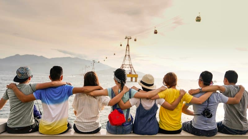 Friends high-fiving and laughing together